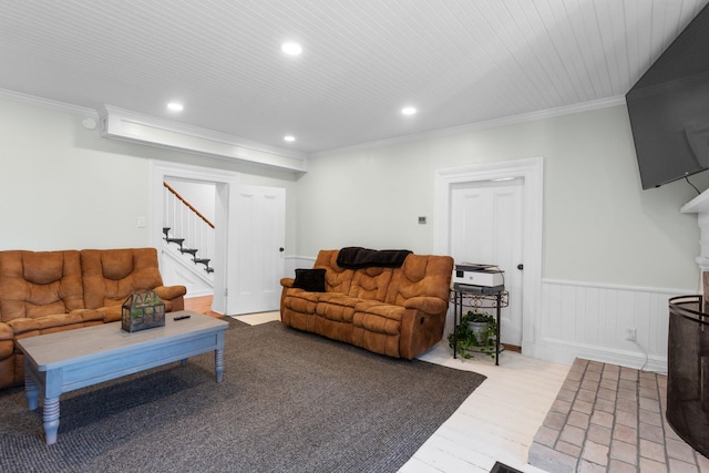 living room featuring light wood-style floors, recessed lighting, crown molding, and stairs