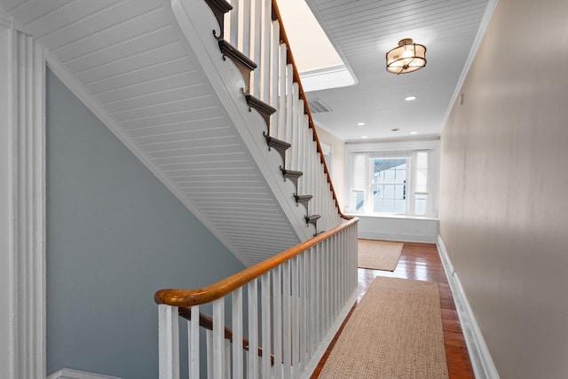 hallway with visible vents, wood finished floors, stairway, baseboards, and recessed lighting