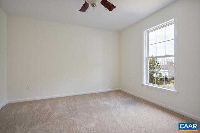 spare room with a ceiling fan, baseboards, and carpet floors