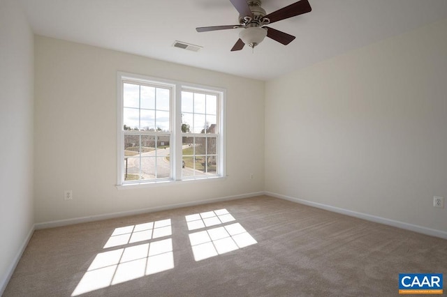 unfurnished room featuring visible vents, baseboards, carpet, and a ceiling fan