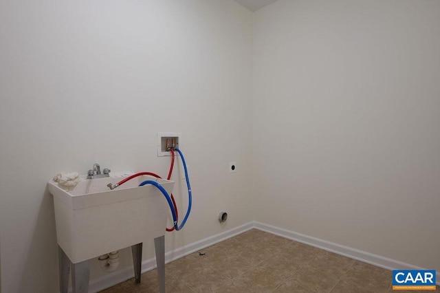 washroom featuring baseboards, washer hookup, and laundry area