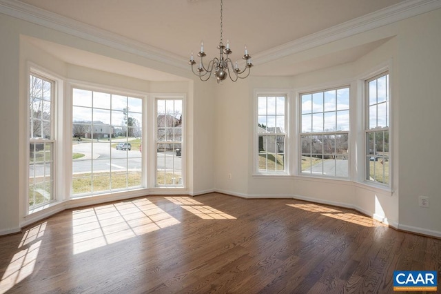 unfurnished dining area featuring a notable chandelier, wood finished floors, baseboards, and ornamental molding