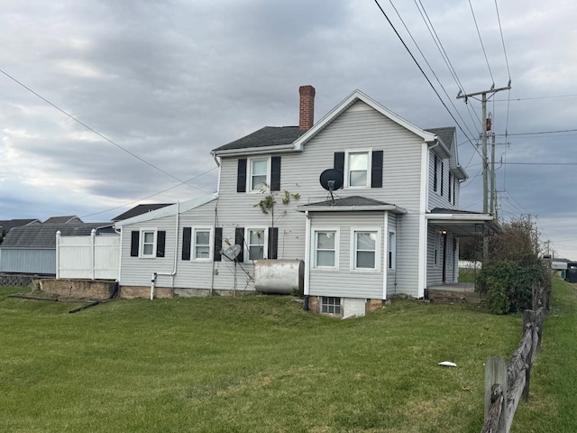 back of house with a lawn