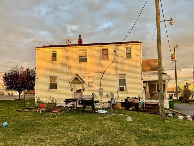 rear view of house with a lawn