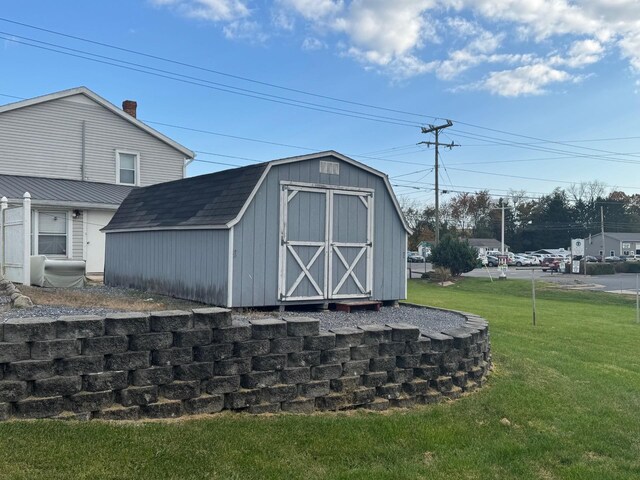 view of outbuilding featuring a lawn