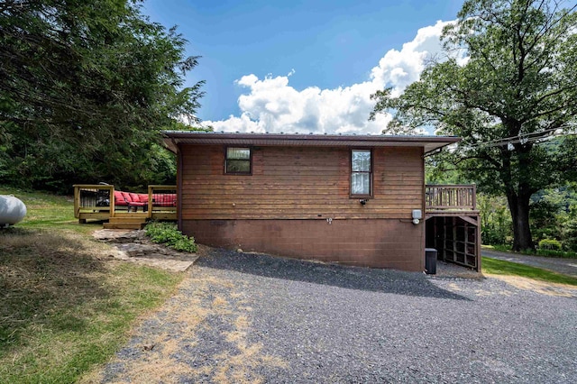 view of side of home with a deck