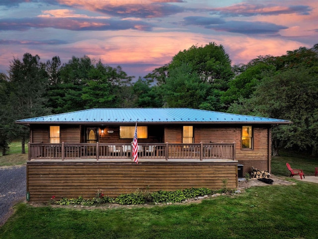 view of front of home featuring a wooden deck and a yard