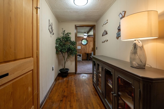 hallway featuring dark hardwood / wood-style floors and a textured ceiling