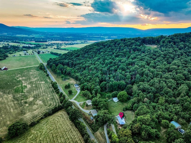 aerial view at dusk featuring a mountain view