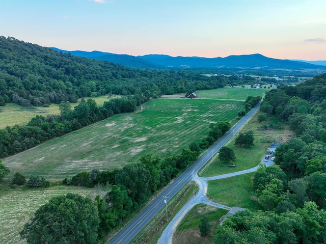 aerial view at dusk featuring a mountain view