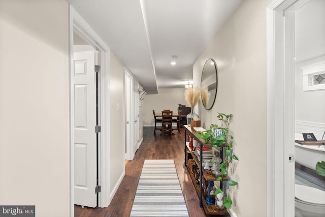 corridor with dark hardwood / wood-style flooring