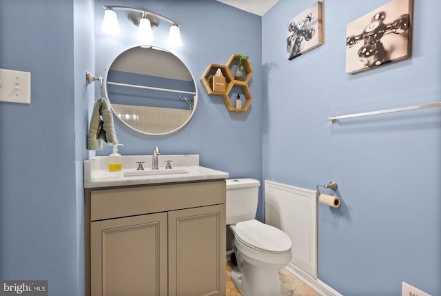 bathroom featuring vanity and toilet