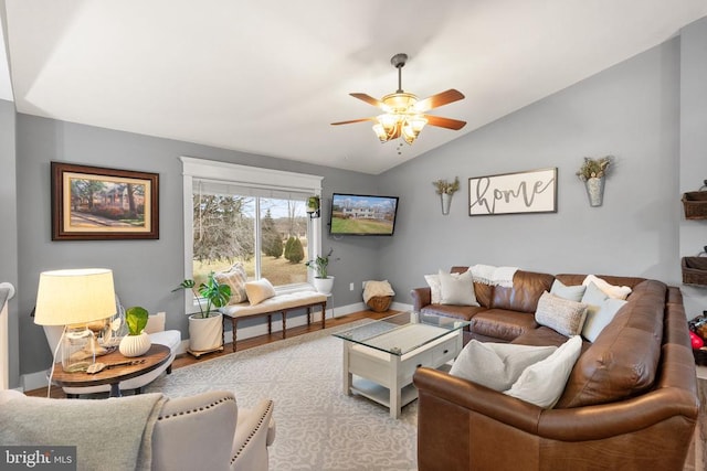 living room with lofted ceiling, light hardwood / wood-style flooring, and ceiling fan