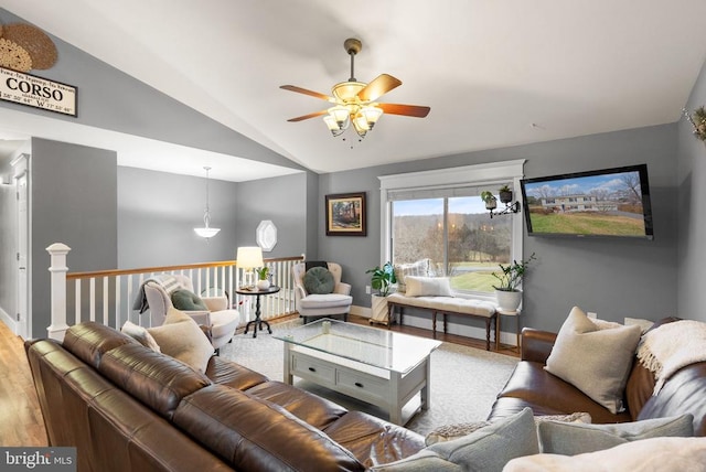 living room with ceiling fan, lofted ceiling, and wood-type flooring