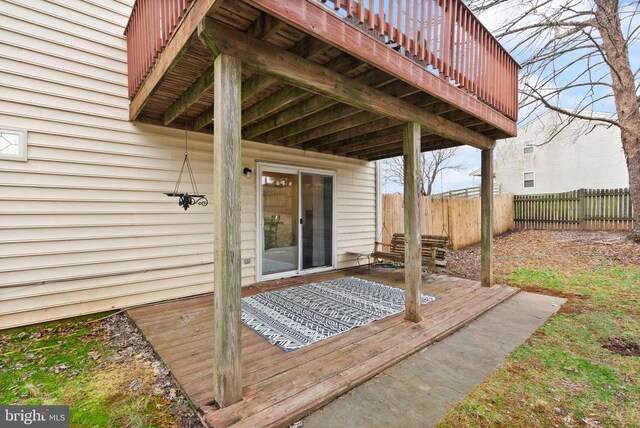 back of house with a wooden deck, a lawn, central air condition unit, and a storage unit