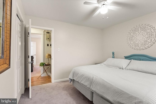 carpeted bedroom featuring ceiling fan and a closet