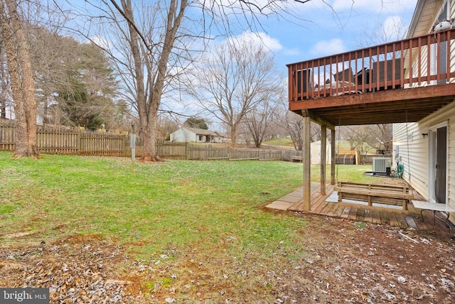 view of yard with a wooden deck and central AC