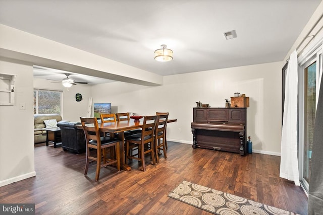 dining space with dark hardwood / wood-style flooring and ceiling fan