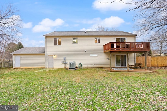 back of property featuring a yard, a deck, and central air condition unit