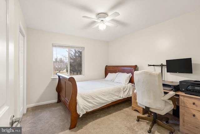 carpeted bedroom with ceiling fan and a closet