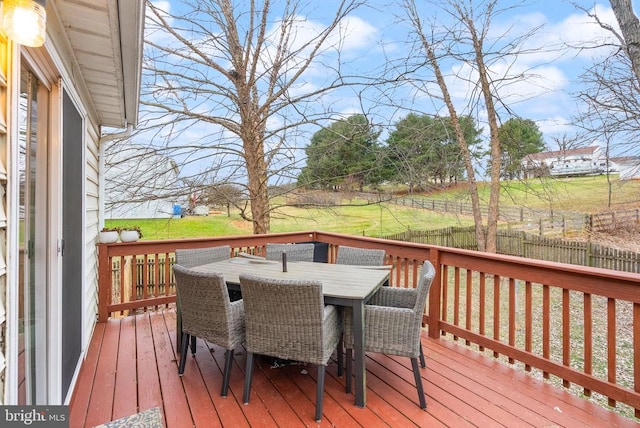 wooden terrace featuring a yard