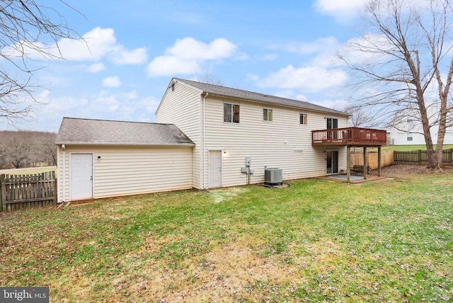 back of house with a wooden deck, a yard, and central AC unit