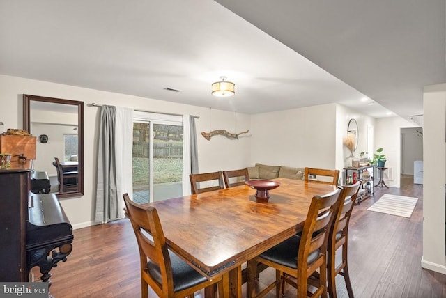 dining space featuring dark wood-type flooring