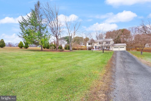 exterior space featuring a garage and a front yard