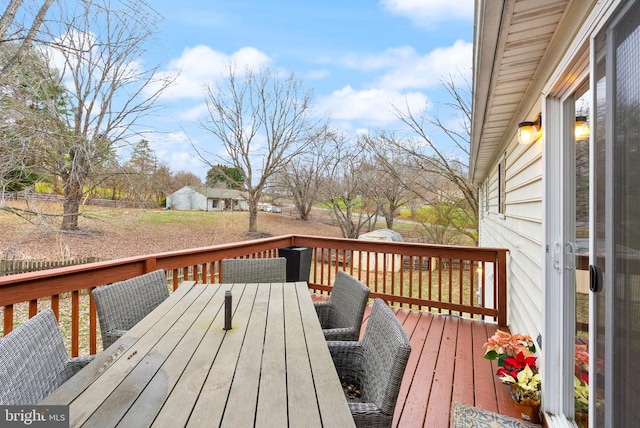 wooden deck with a storage shed