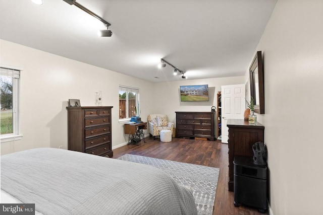 bedroom featuring dark wood-type flooring and track lighting