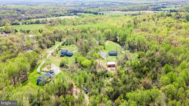 birds eye view of property featuring a wooded view