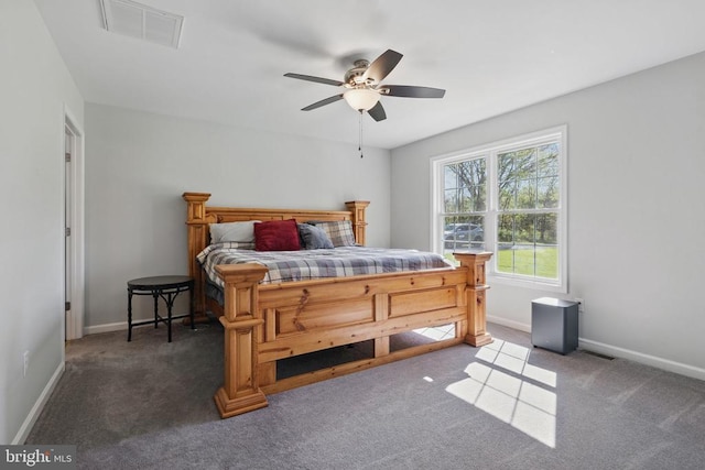 carpeted bedroom with a ceiling fan, baseboards, and visible vents