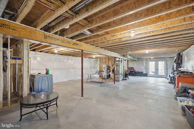 basement with heating unit, french doors, and water heater