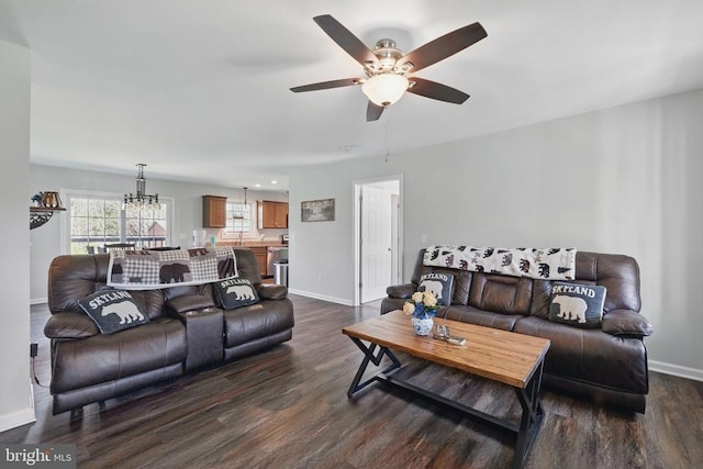 living area with baseboards, ceiling fan with notable chandelier, and dark wood-style flooring