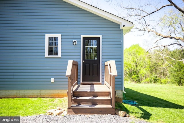 doorway to property featuring a yard