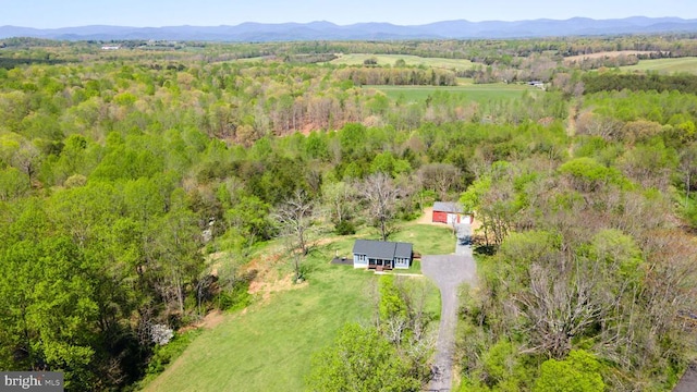 birds eye view of property with a mountain view, a rural view, and a forest view