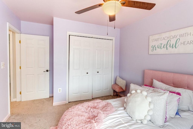 carpeted bedroom with baseboards, a closet, and ceiling fan