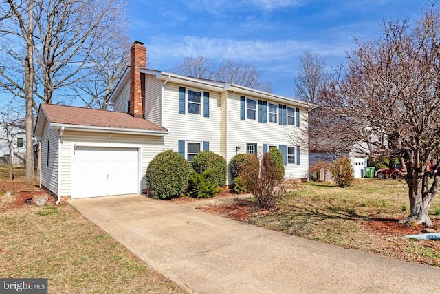 colonial home featuring driveway, an attached garage, and a chimney