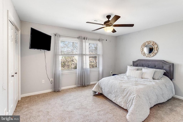 bedroom featuring carpet, baseboards, a closet, and ceiling fan