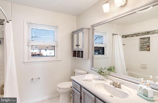 full bath featuring baseboards, toilet, and vanity