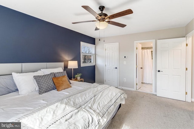 carpeted bedroom with baseboards and a ceiling fan