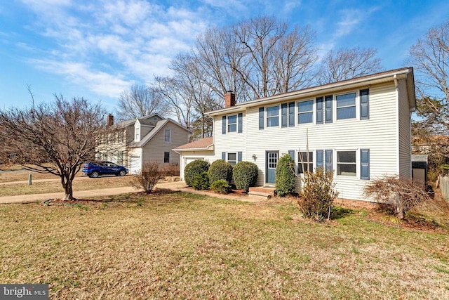 view of front of property with a front yard, a garage, and a chimney