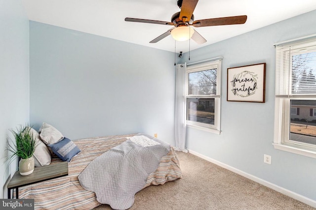 carpeted bedroom featuring a ceiling fan and baseboards