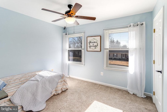 bedroom featuring a ceiling fan, baseboards, and carpet floors