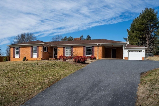 ranch-style home featuring an attached garage, brick siding, fence, driveway, and a front lawn