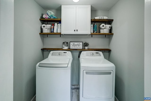 laundry room featuring cabinet space and separate washer and dryer