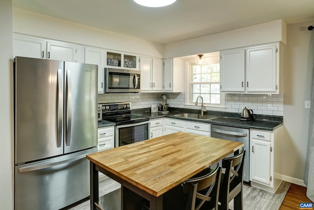 kitchen featuring a sink, white cabinets, and stainless steel appliances