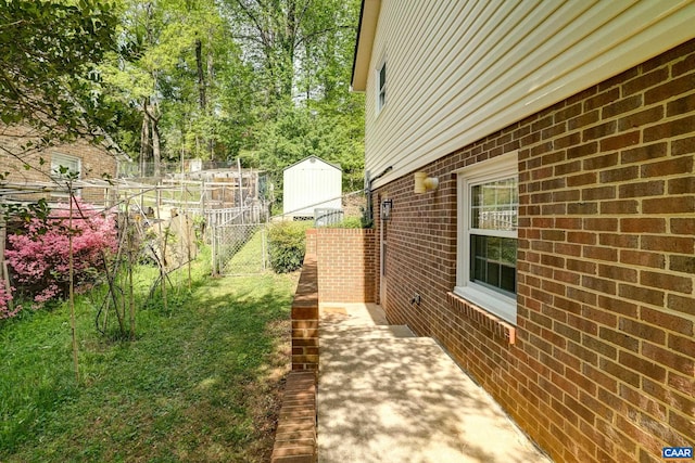 view of side of home featuring brick siding and fence