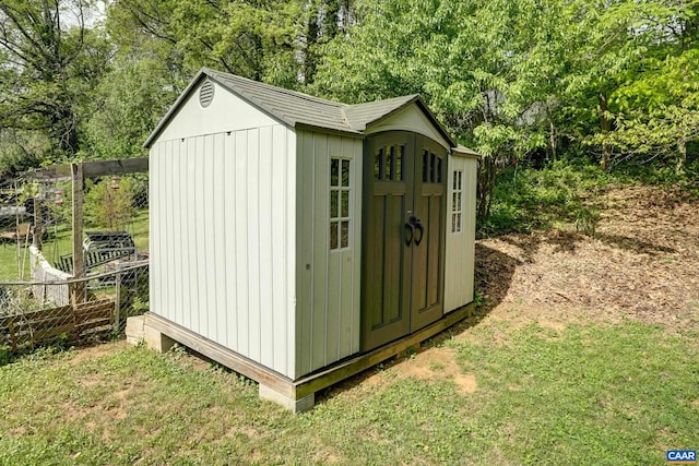 view of shed featuring fence