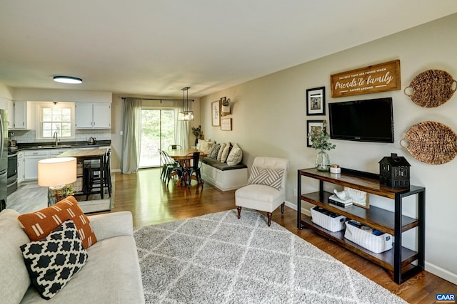 living area featuring baseboards and wood finished floors